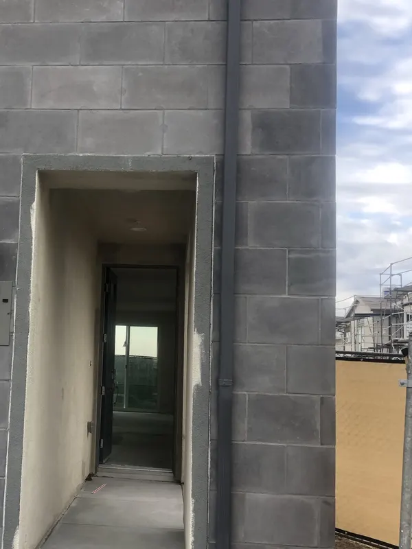 Split-face concrete block forms an entry alcove surround at a multifamily building.